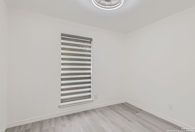 empty room with light hardwood / wood-style flooring