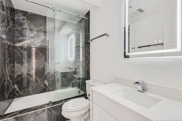 full bathroom with vanity, toilet, and bath / shower combo with glass door