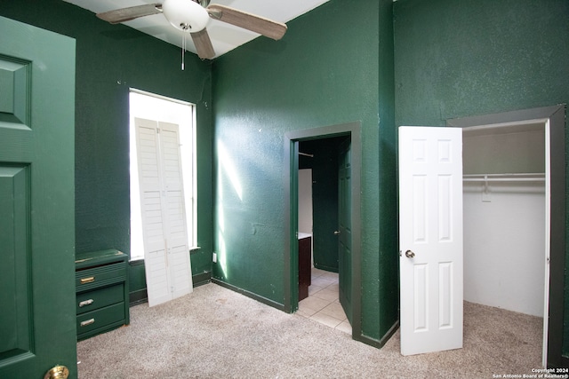 carpeted bedroom with a closet and ceiling fan