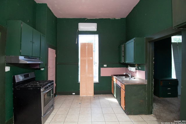 kitchen featuring light tile patterned flooring, a healthy amount of sunlight, sink, and stainless steel gas range