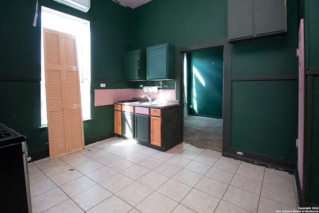 kitchen featuring black electric range oven, sink, and light tile patterned floors