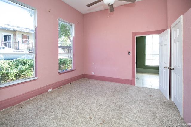 unfurnished room with ceiling fan and light colored carpet