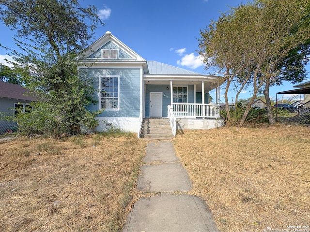 view of front of property with a porch and a front lawn