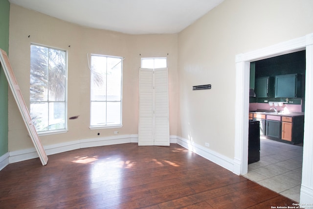 empty room featuring a wealth of natural light and hardwood / wood-style floors