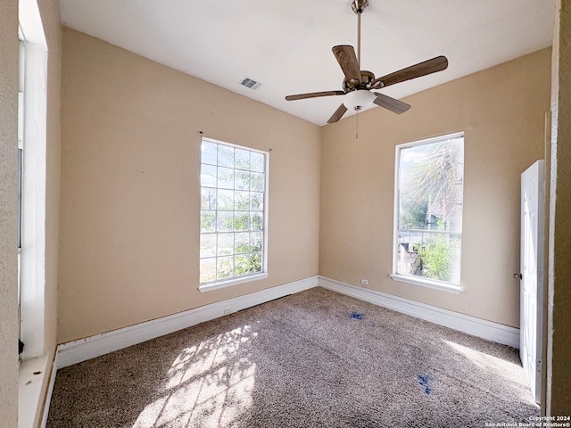 spare room with ceiling fan and carpet