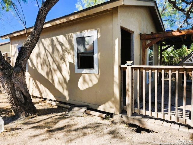 view of side of property featuring a wooden deck