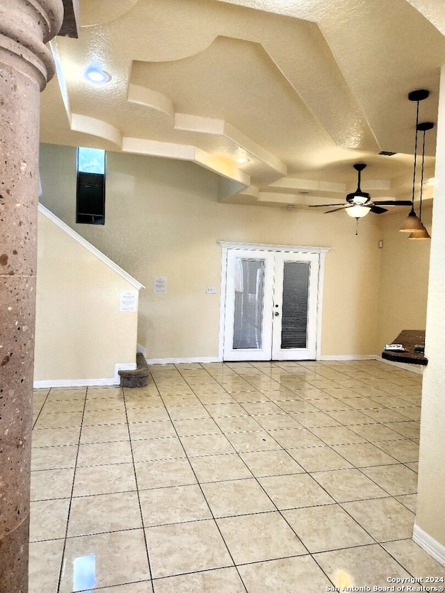 unfurnished living room featuring french doors, light tile patterned flooring, a textured ceiling, and ceiling fan