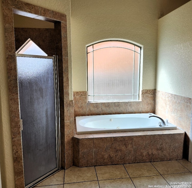 bathroom featuring tile patterned flooring and plus walk in shower