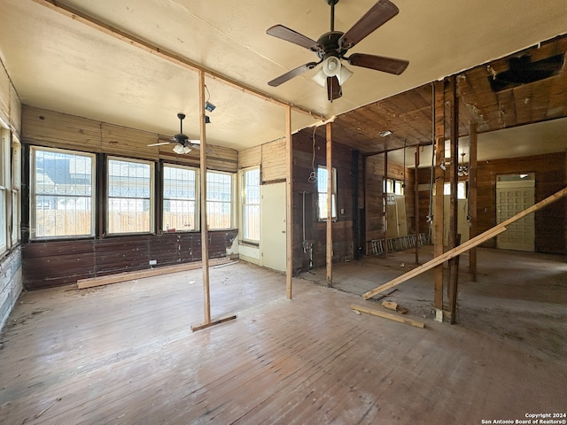 miscellaneous room featuring wood walls, hardwood / wood-style floors, and ceiling fan