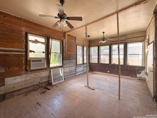 unfurnished sunroom with cooling unit and ceiling fan