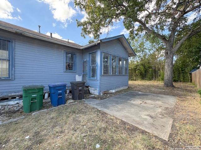 view of property exterior with a patio