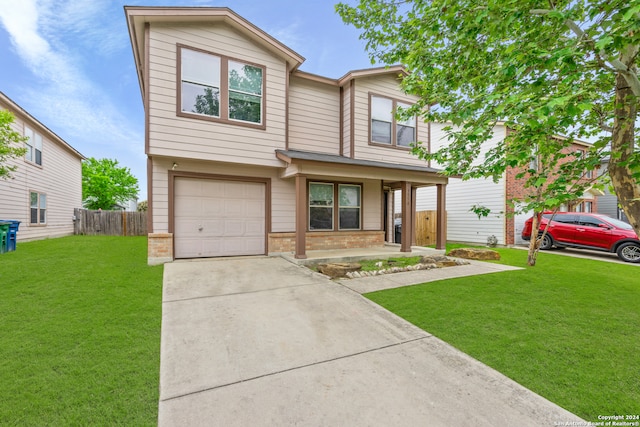 view of front of home with a front lawn and a garage