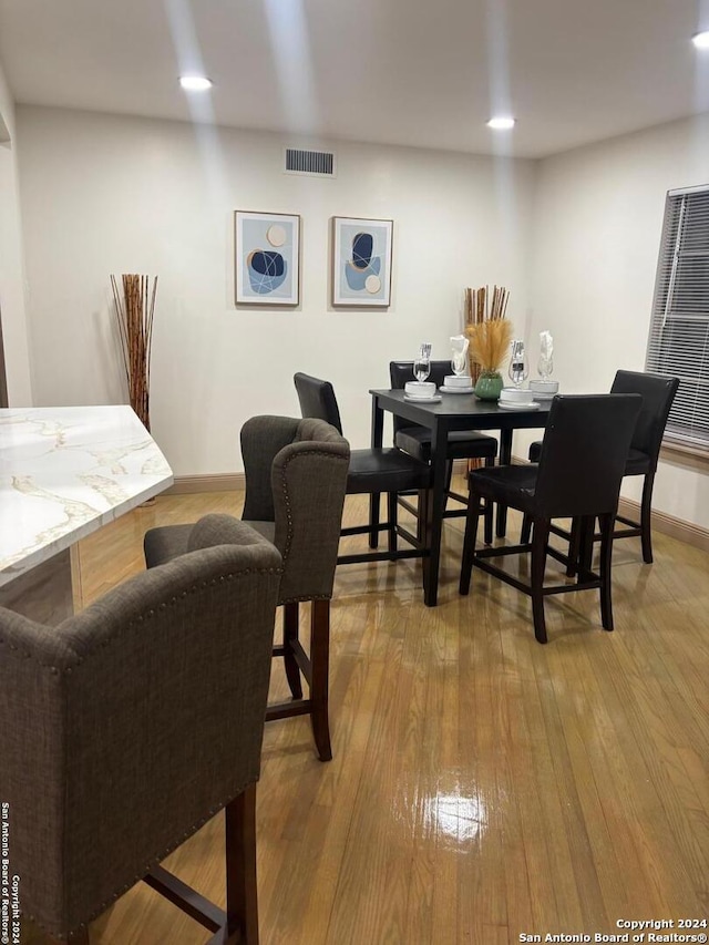 dining space with visible vents, recessed lighting, baseboards, and wood-type flooring