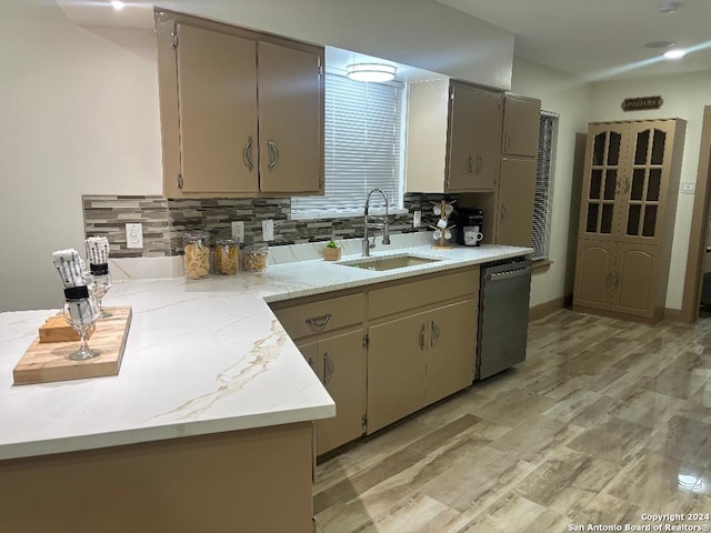 kitchen with gray cabinets, tasteful backsplash, stainless steel dishwasher, and a sink