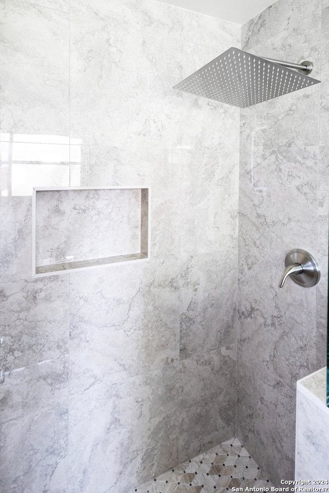 bathroom with tiled shower