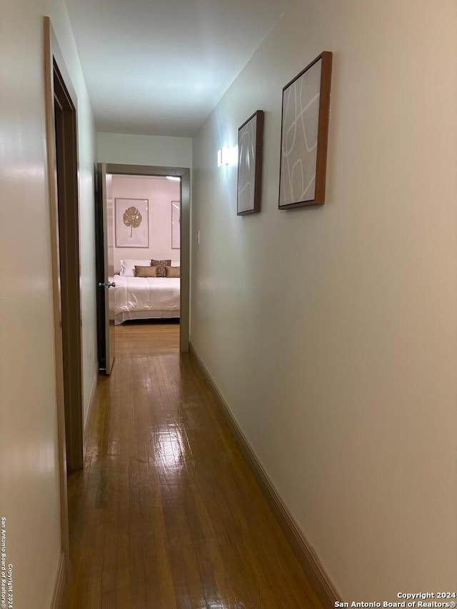 corridor with hardwood / wood-style floors