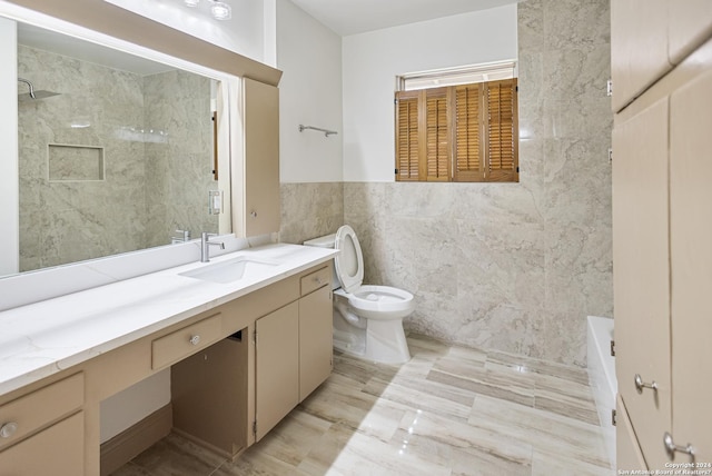full bathroom with toilet, walk in shower, vanity, and tile walls