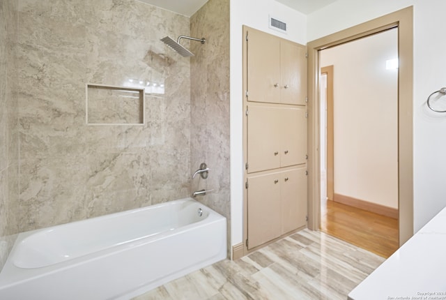 bathroom featuring tiled shower / bath and hardwood / wood-style floors