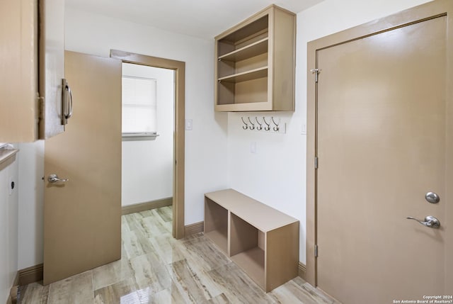 mudroom featuring light wood-style flooring and baseboards