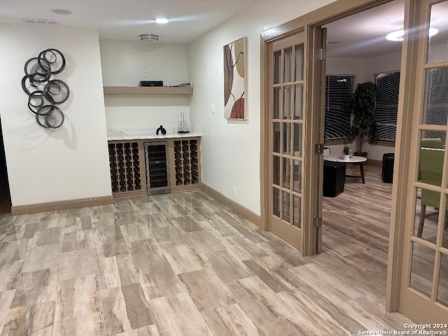 interior space featuring wine cooler and light hardwood / wood-style flooring