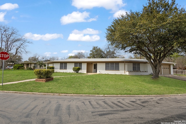 ranch-style home with a front lawn and a garage