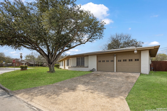 ranch-style house with a front yard and a garage