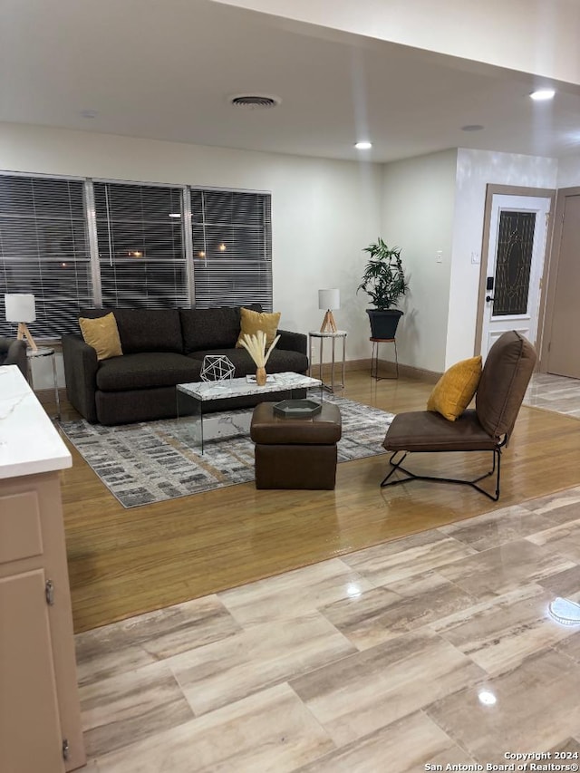 living area with visible vents and recessed lighting