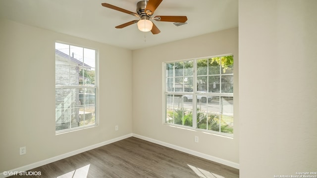 spare room featuring hardwood / wood-style flooring and ceiling fan