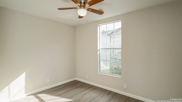 unfurnished room featuring ceiling fan and light wood-type flooring