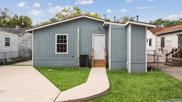 view of outdoor structure with a yard and central AC unit