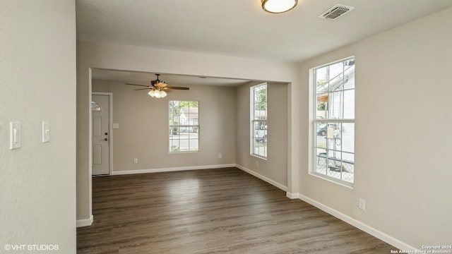 empty room with dark hardwood / wood-style floors and ceiling fan