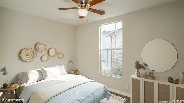 bedroom with ceiling fan and hardwood / wood-style floors