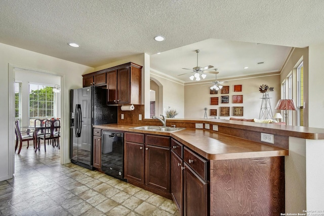 kitchen featuring kitchen peninsula, ceiling fan, black appliances, dark brown cabinetry, and sink