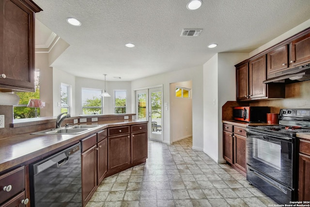 kitchen featuring sink, appliances with stainless steel finishes, decorative light fixtures, and dark brown cabinetry