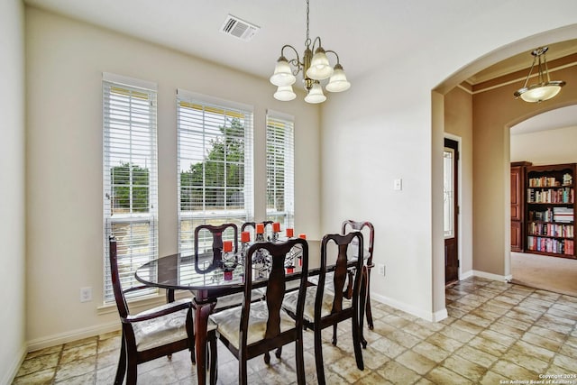 dining area with an inviting chandelier and crown molding