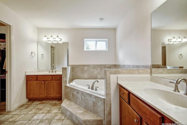 bathroom featuring vanity and tiled bath