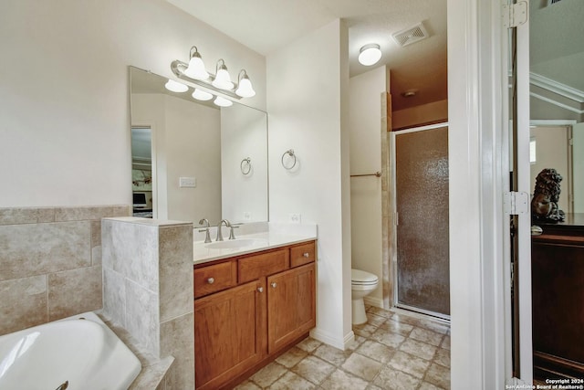 full bathroom with vanity, shower with separate bathtub, and toilet