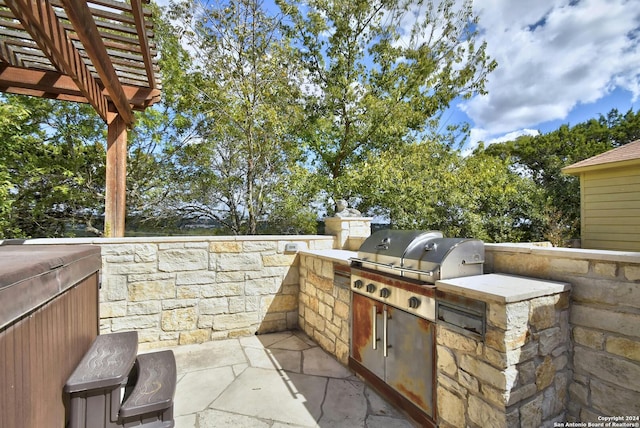 view of patio / terrace with a pergola, a grill, and exterior kitchen