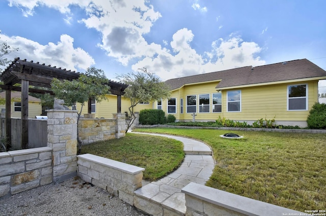 exterior space with a pergola and a lawn