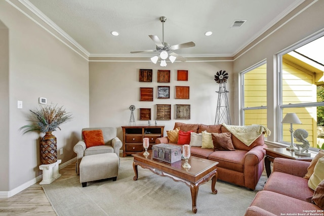 living room with light hardwood / wood-style floors, ornamental molding, and ceiling fan