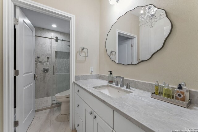 bathroom featuring toilet, walk in shower, and vanity