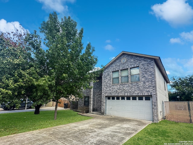 view of property with a garage and a front lawn