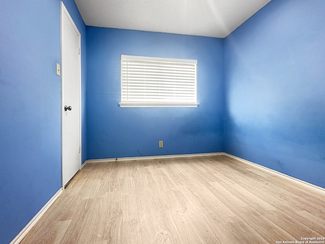 unfurnished room with light hardwood / wood-style floors