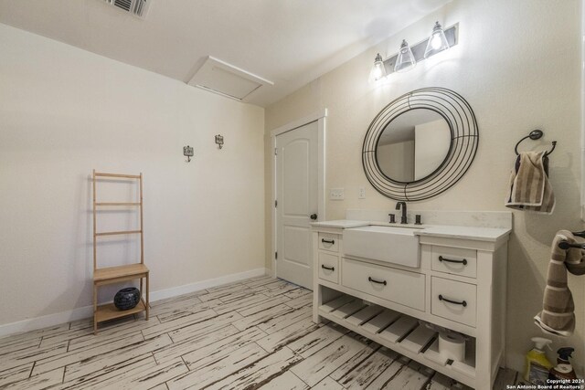 1627 Forest Lake Dr, Spring Branch, TX 78070 - bathroom featuring vanity, baseboards, visible vents, and wood finished floors