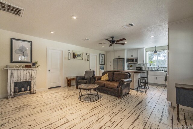 1627 Forest Lake Dr, Spring Branch, TX 78070 - living area featuring light wood-style floors, ceiling fan, visible vents, and recessed lighting
