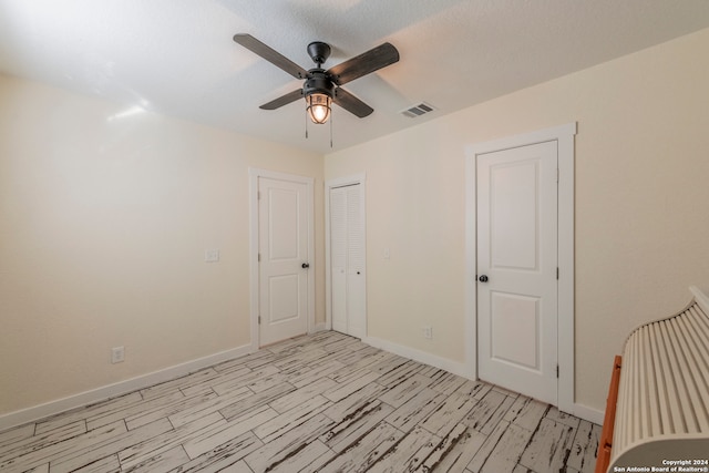 empty room with light wood-type flooring and ceiling fan