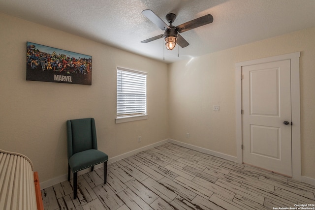 unfurnished room with a textured ceiling and ceiling fan