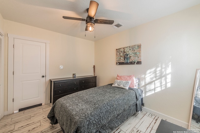 bedroom featuring light wood-type flooring and ceiling fan