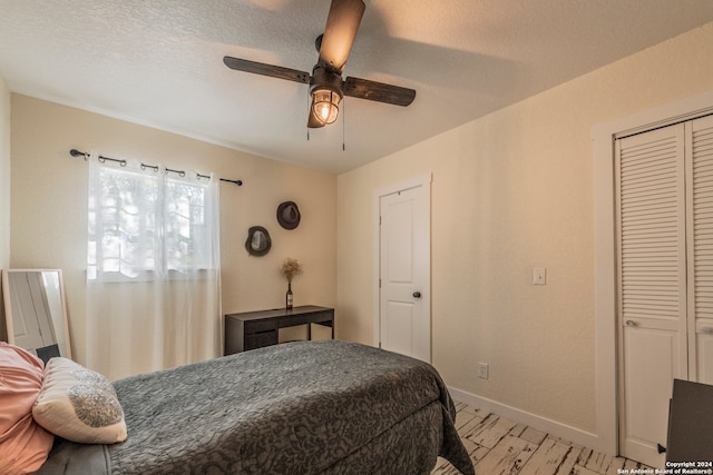 bedroom featuring a closet, a textured ceiling, and ceiling fan