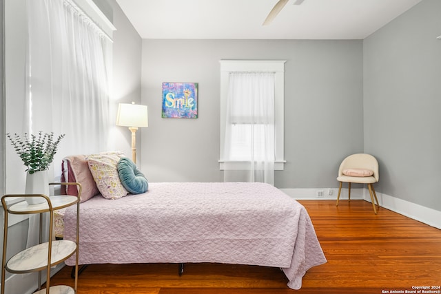 bedroom with wood-type flooring and ceiling fan